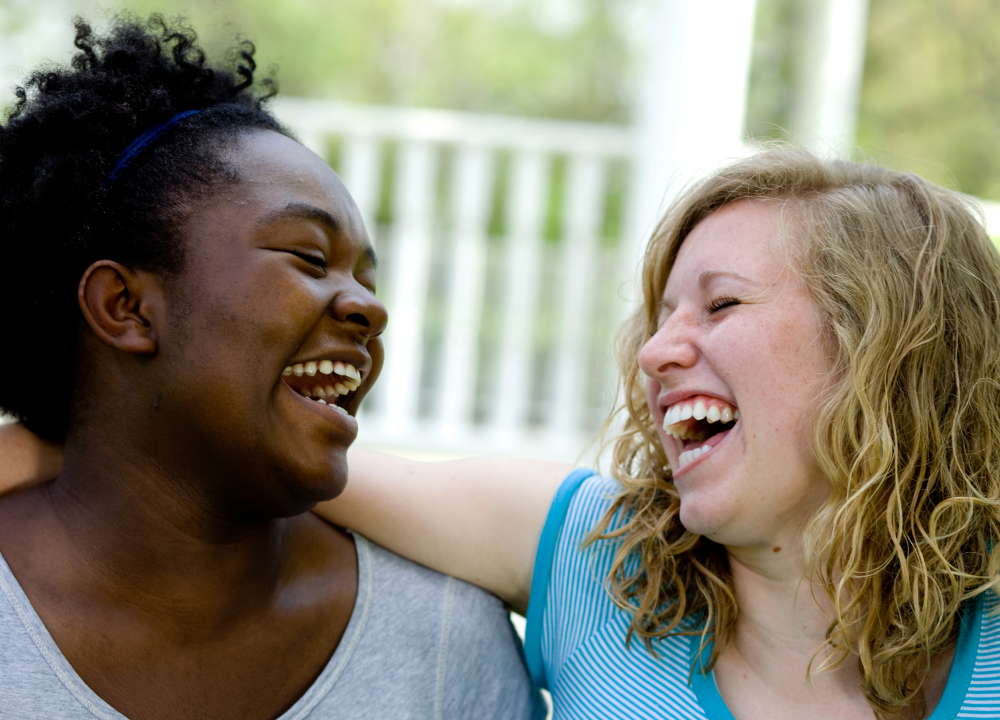 Two young women laughing together