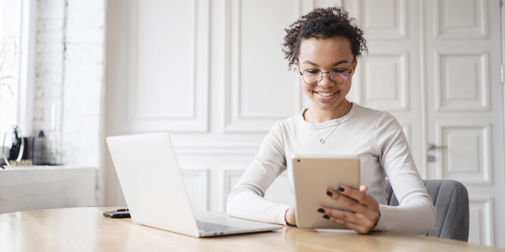 A Business Data Analytics Specialist uses a tablet to analyze business data.