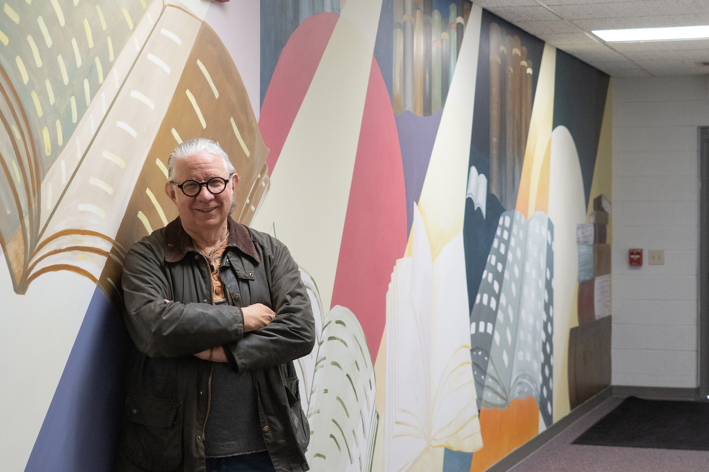 Mount Vernon Nazarene University Art Professor John Donnelly, left, created this mural, in partnership with the Education Department, highlighting the university’s mission of educating the whole person. It is located on the second floor of Hyson Campus Center. (Photo courtesy of Mount Vernon Nazarene University)