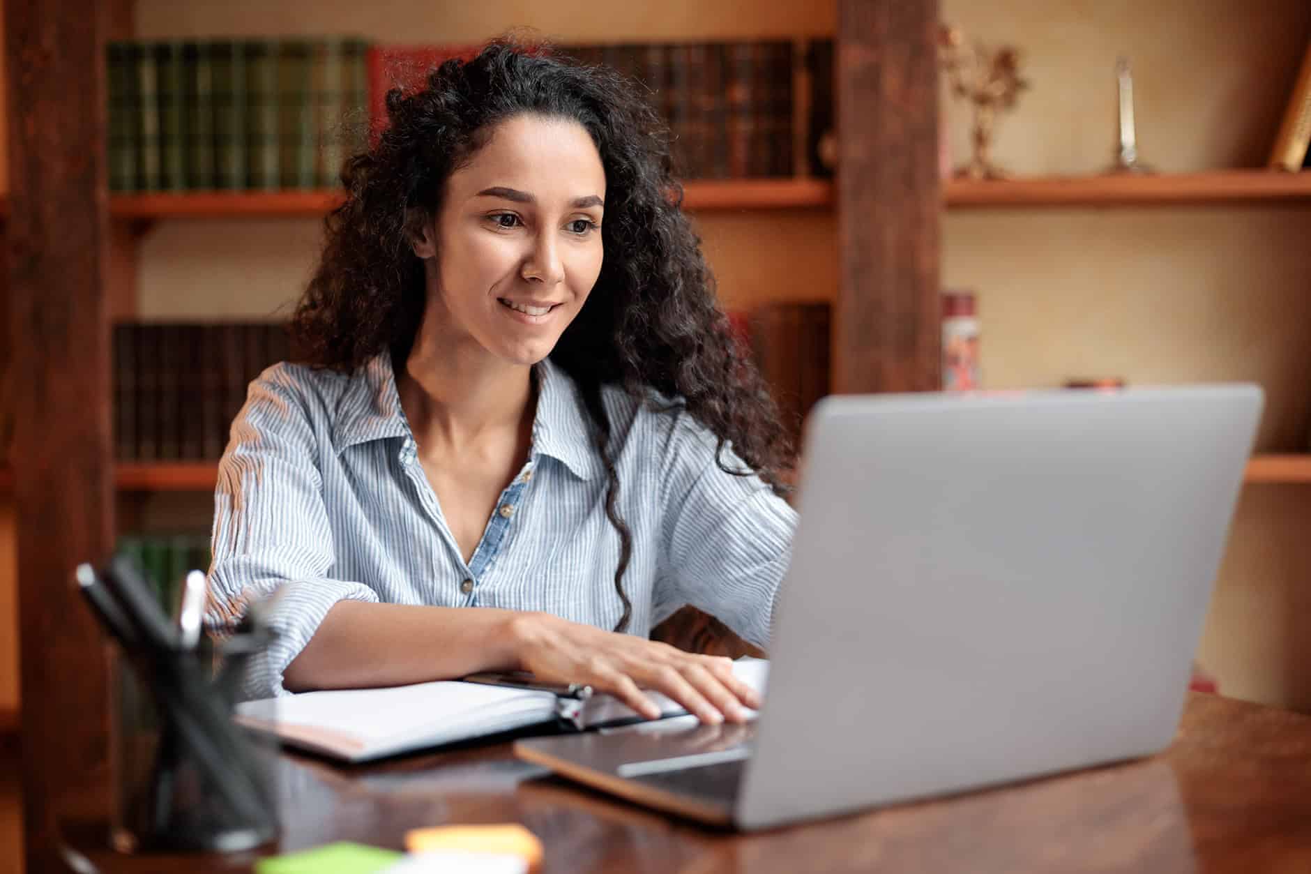 woman-sitting-at-table-using-computer-and-typing-2023-11-27-04-54-18-utc (1)