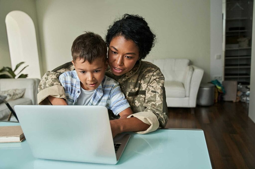 A mom working iwth her young son on the computer