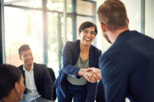 Public Administration businesswoman shakes hand with new team member.