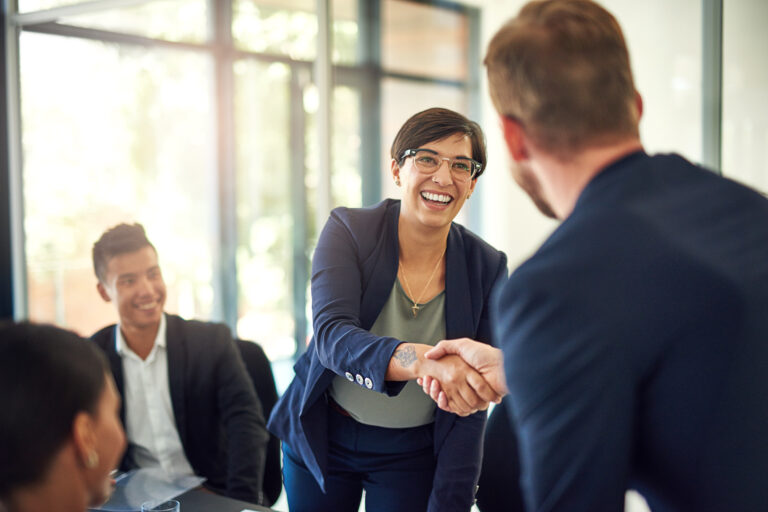 Public Administration businesswoman shakes hand with new team member.