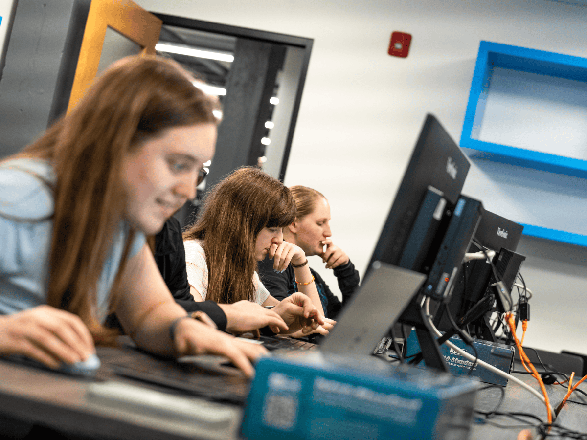 Students focused on their screens during a computer programming class.