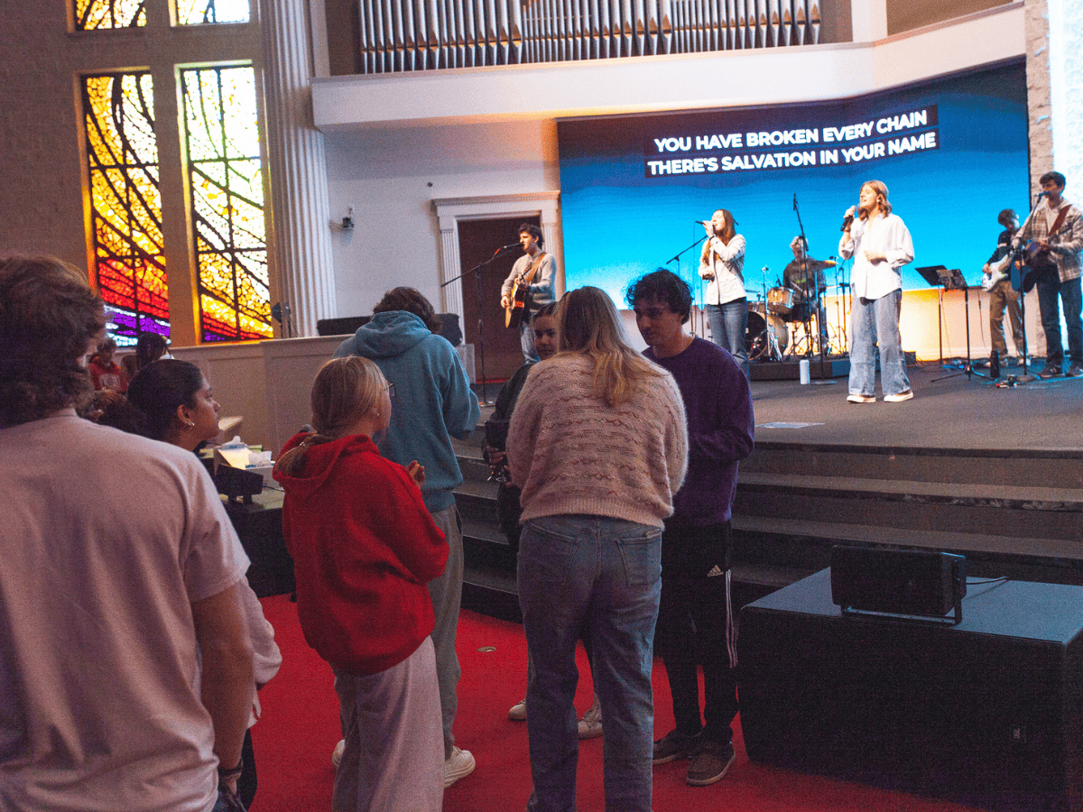 People praying and singing during a religious service.