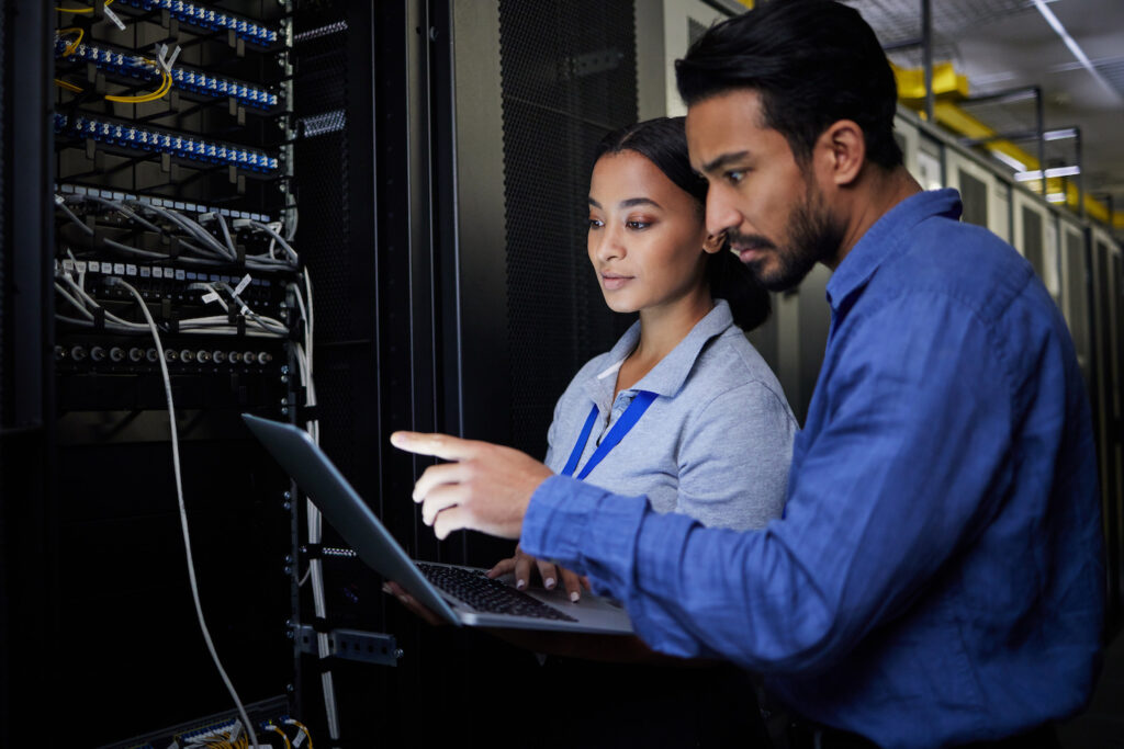 People, maintenance or laptop in server room, IT engineering or software programming ideas in cyber.