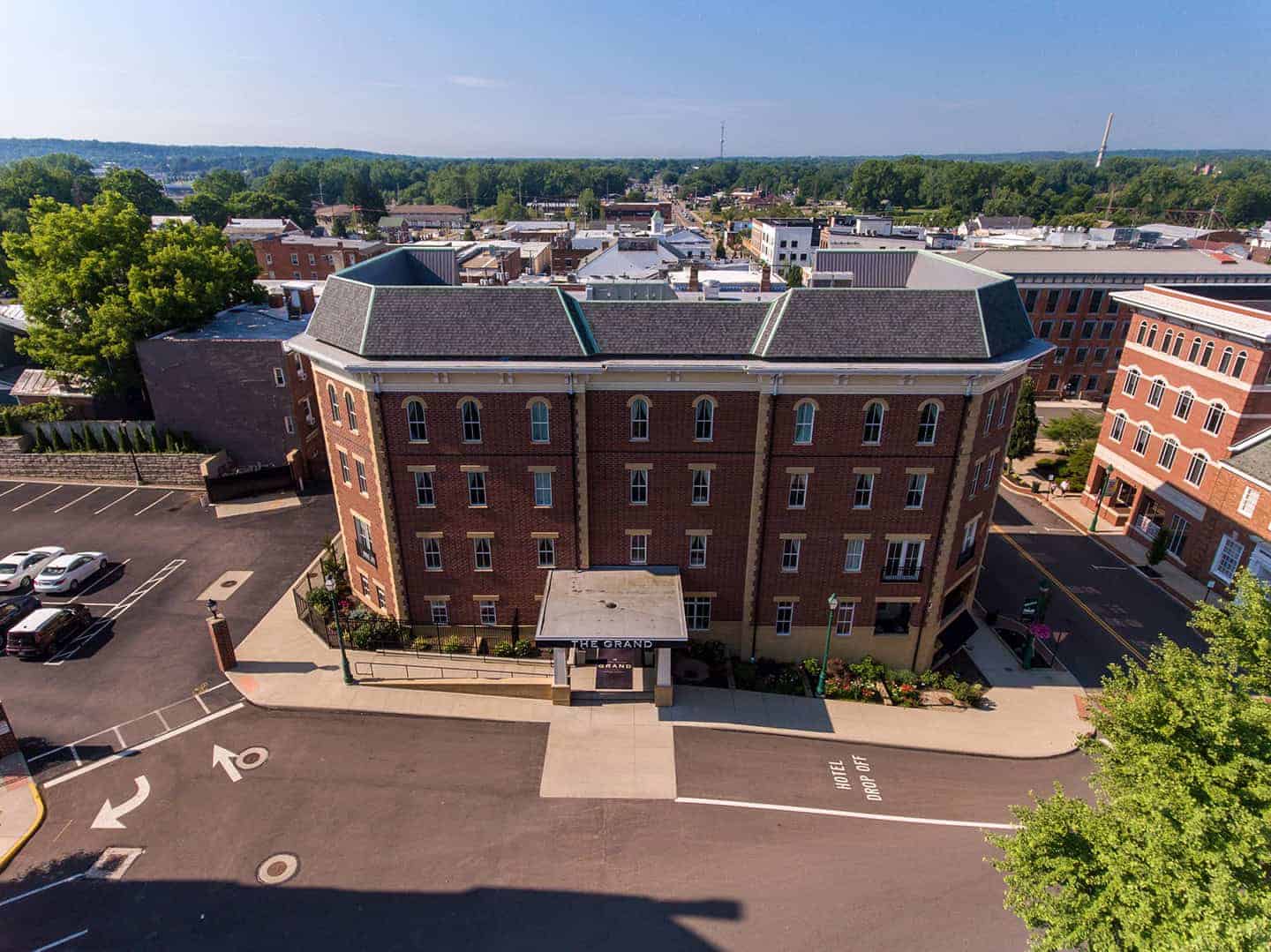 Historic brick building with multiple floors and a central entrance, situated in an urban area.