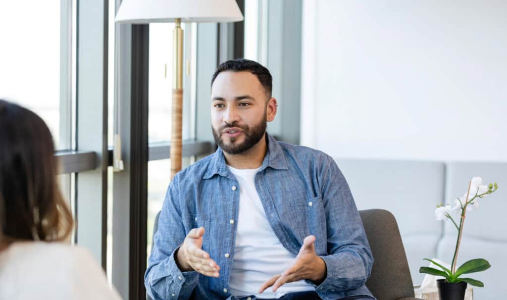 A mental health counselor speaks with a client in a bright office, reflecting MVNU’s online programs that prepare students for impactful careers in counseling and mental health services.