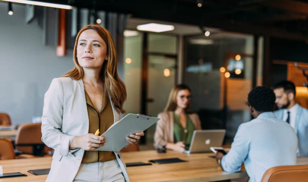 Business professional leading a team meeting, representing how MVNU Online business degrees help adults advance into leadership roles.