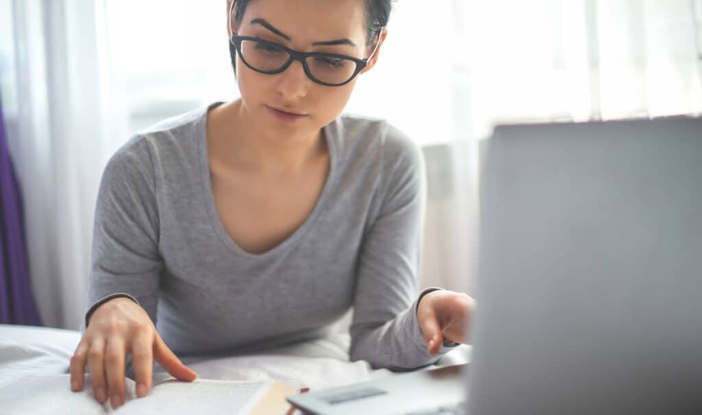 An adult online student studying Scripture alongside coursework, representing how Christian online learning at MVNU integrates faith with higher education.