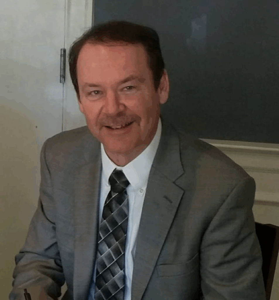 "Professional man in gray suit smiling at camera".