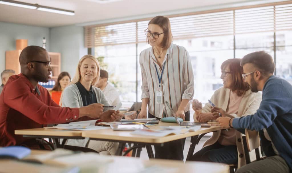 Educators collaborating in a classroom, demonstrating education leadership skills through teamwork and instructional leadership.