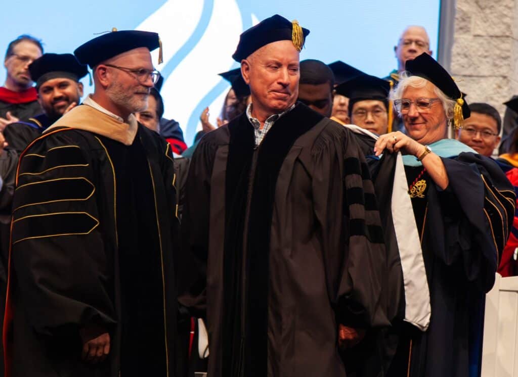 University graduation ceremony with faculty in academic regalia.