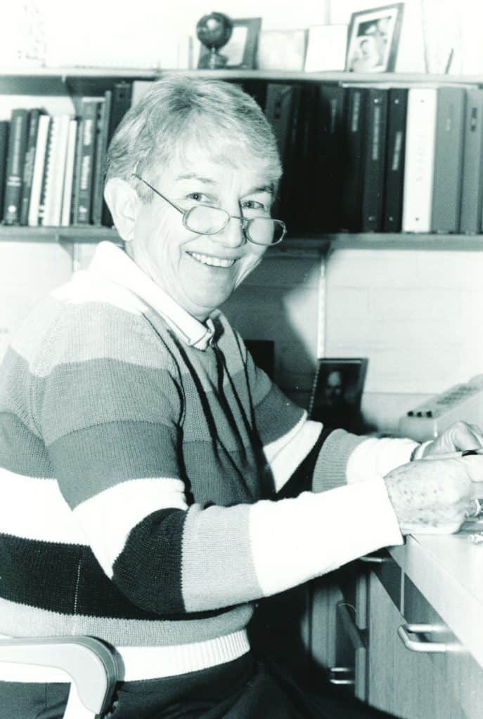 Dr. Lora “Doc” Donoho working at her desk in an office.