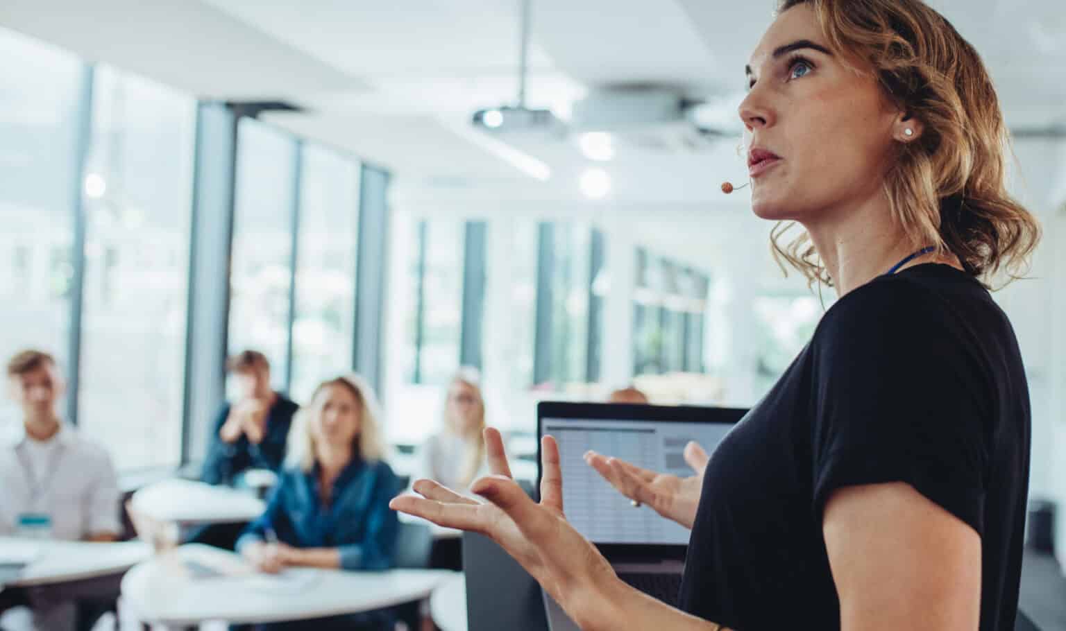 Professional woman presenting strategy to a team in a modern office setting, representing leadership development through MVNU Online graduate programs in business and management.