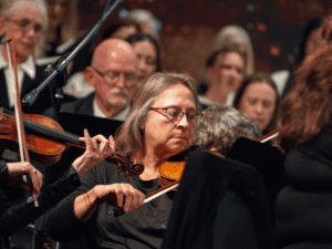 Orchestra performing Handel’s Messiah at MVNU, with focused musicians and conductor.