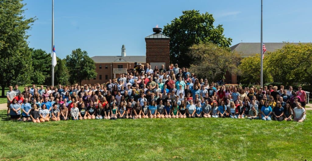 Large group of students and staff gathered outdoors on MVNU campus.