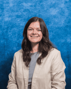 Portrait of Julia Jolliff with a blue textured background.