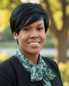 Portrait of Dr. Kameka Tammy Brown outdoors with trees in background.