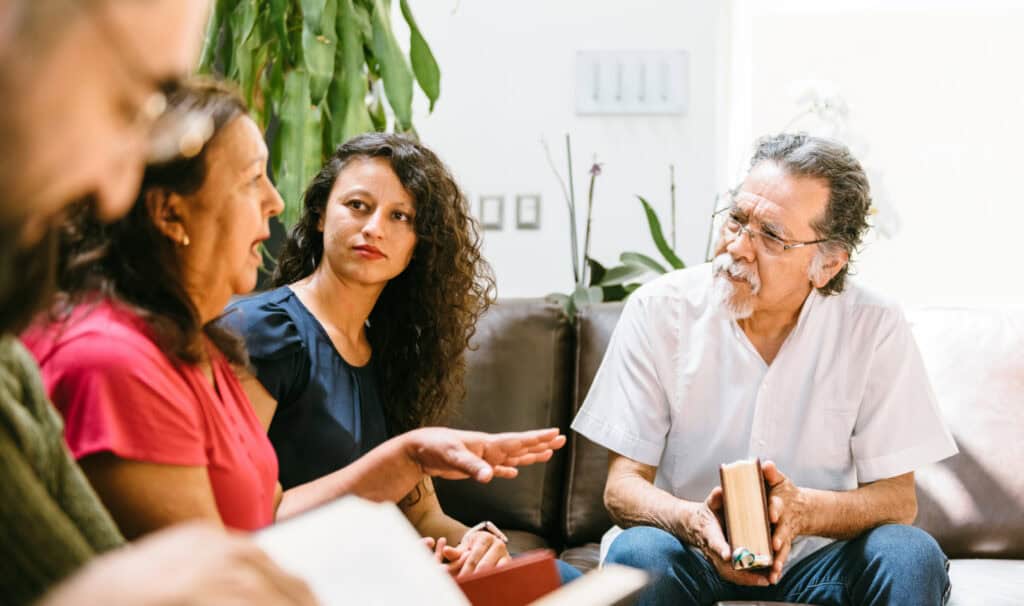 Adults of different ages gathered for a Bible discussion in a home, illustrating the ministry leadership developed in an MVNU Online Master of Ministry.