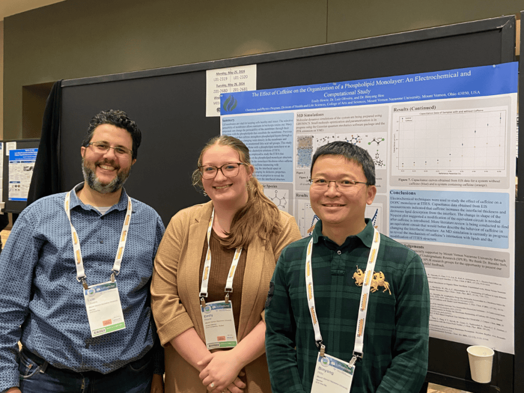 Three students presenting a research poster at a summer program event.