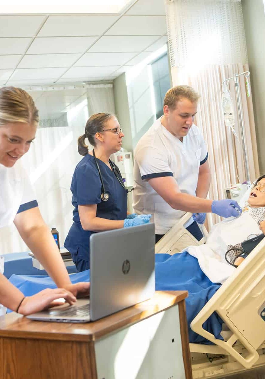 Nursing team caring for patient in hospital ICU with medical equipment.