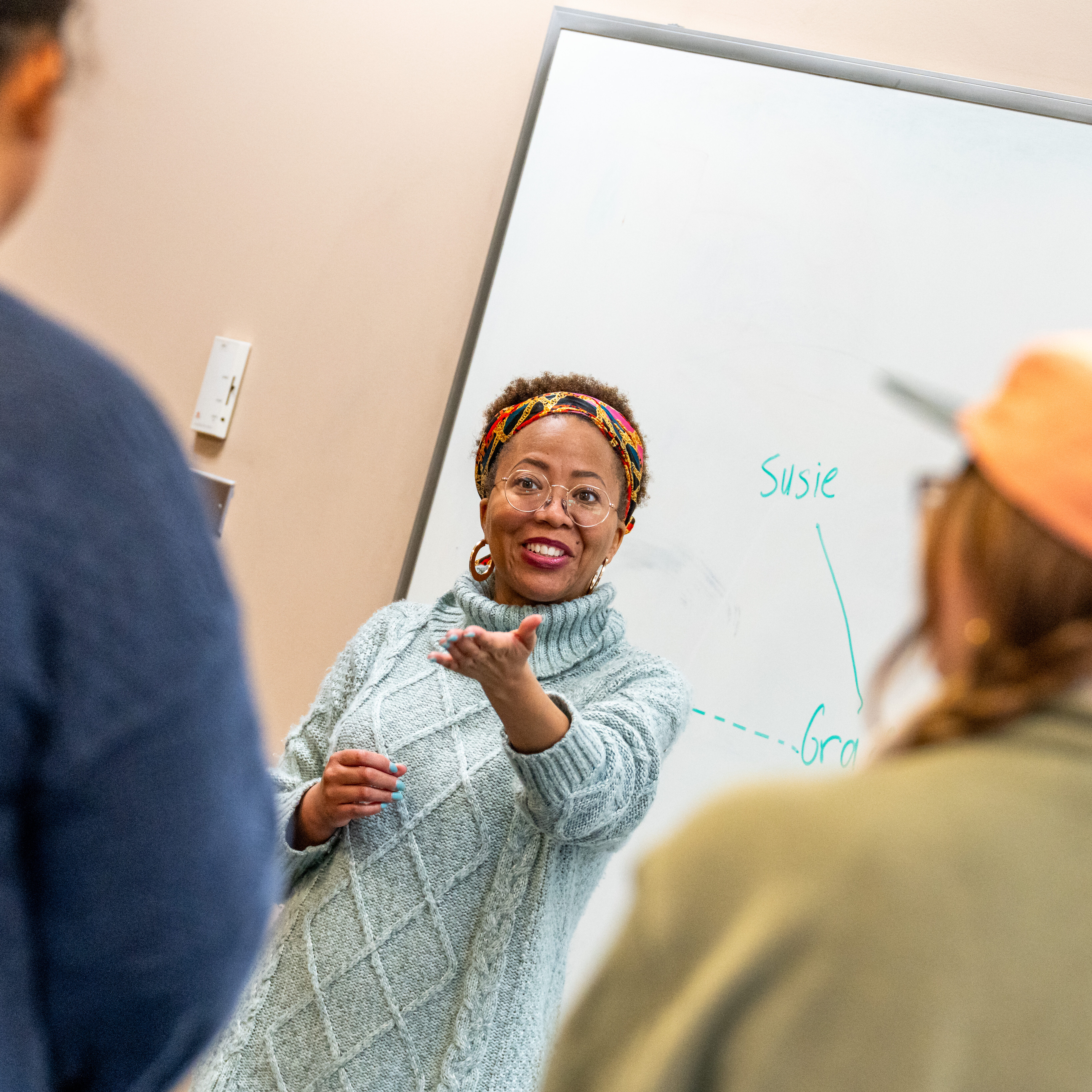 Empowering woman teacher engaging students in classroom discussion.