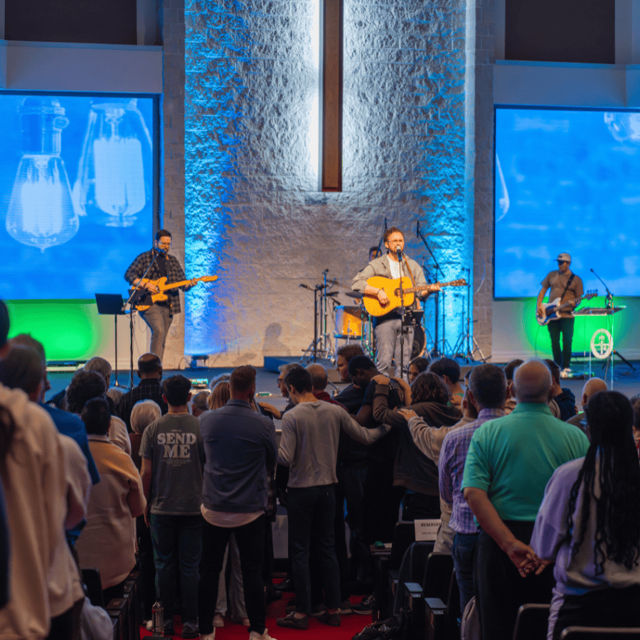 A vibrant church service with a live band performing on stage in front of a congregation.