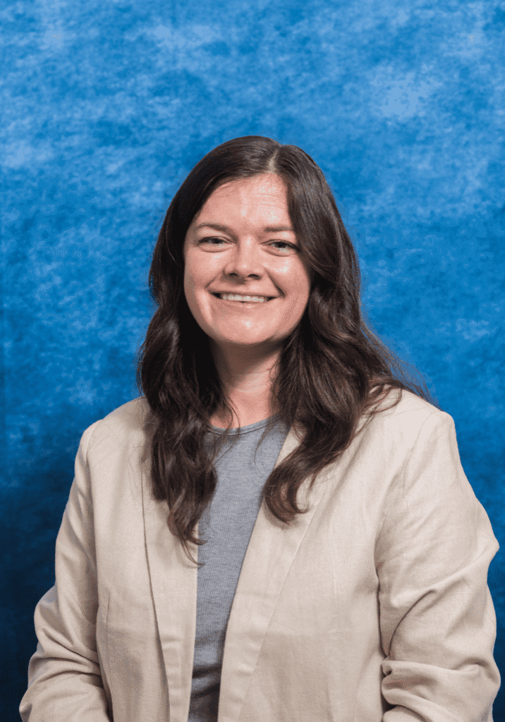 Portrait of Julia Jolliff with a blue textured background.