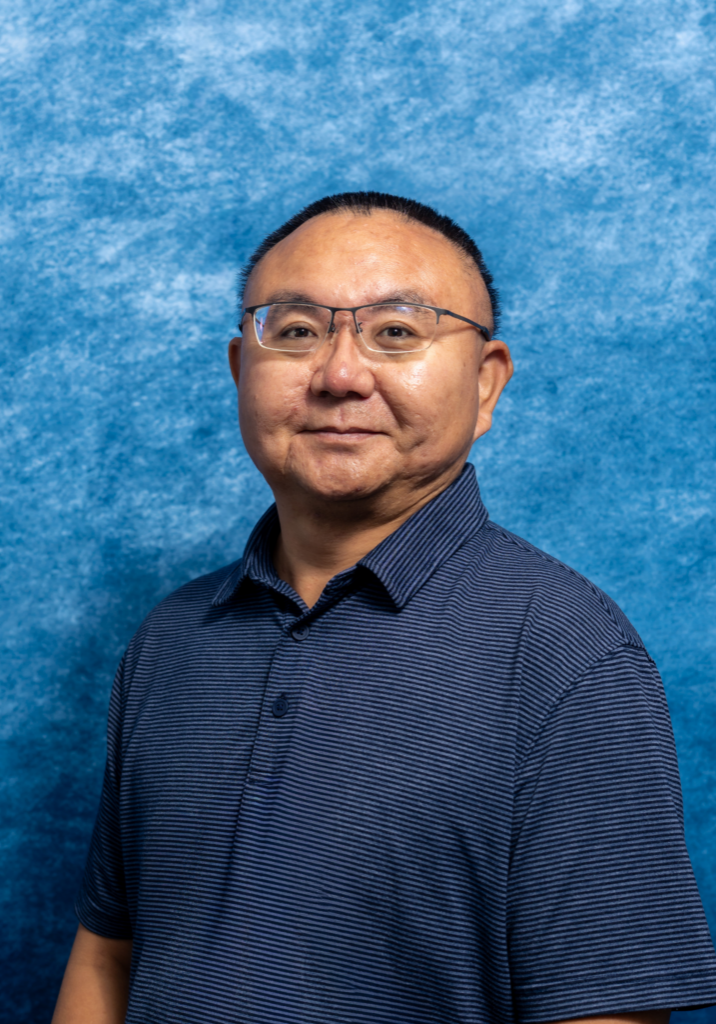 Portrait of Dr. Minfeng Li in a blue shirt against a blue background.