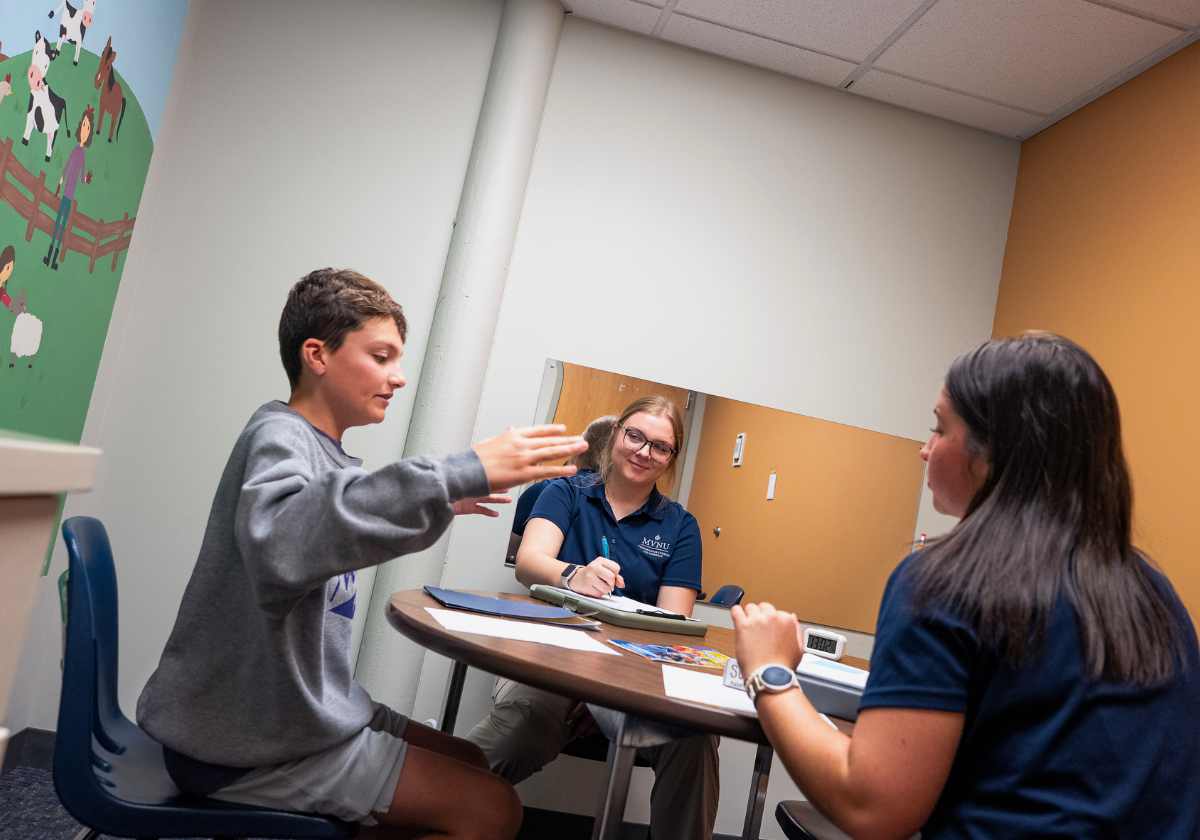 "Group therapy session with three young women in a counseling room".