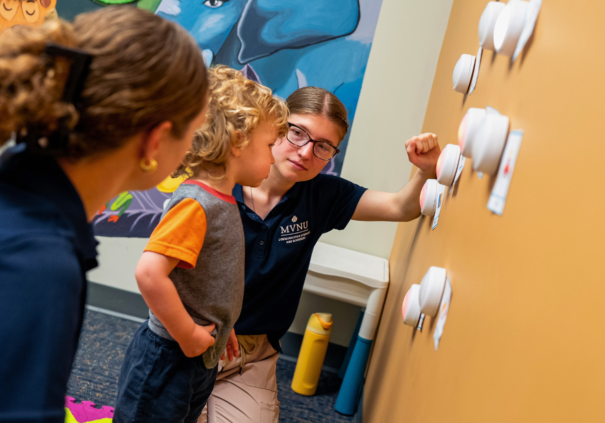 "Children and instructor engaging with interactive wall panels in a classroom setting".