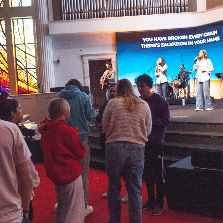 People praying and singing during a religious service.